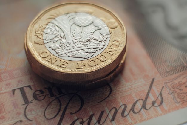 Pound coins and a £10 note