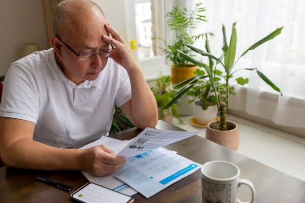 A man looking worried at his energy bills