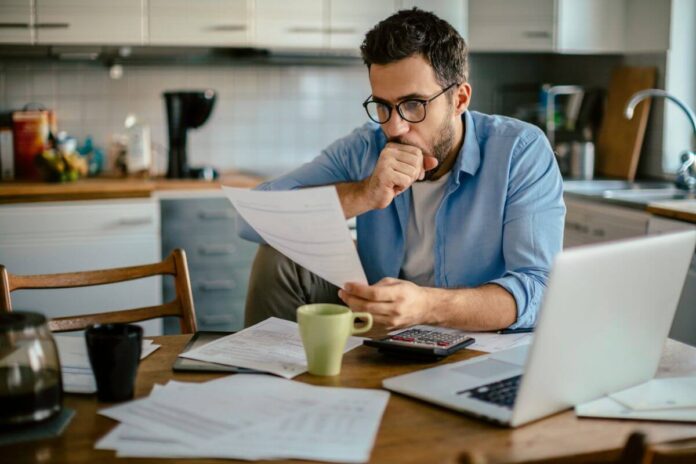 man stressing over bills